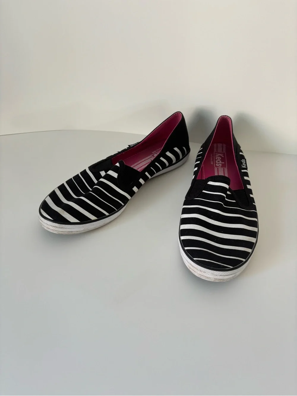 Keds Women’s Black & White Striped Slip-On Sneakers with Pink Insole